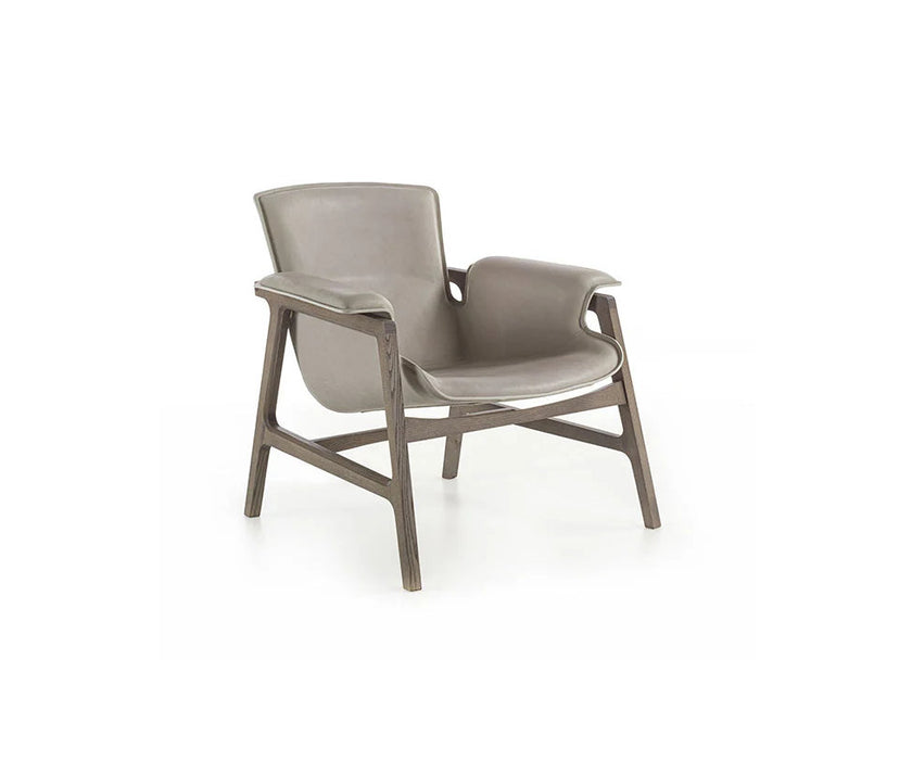 Luxury Arianna armchair by Frigerio with a solid ashwood frame and premium fabric or leather upholstery at Casa Design Group.