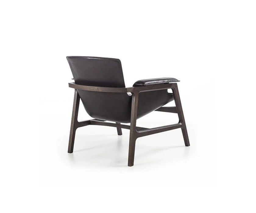 Luxury Arianna armchair by Frigerio with a solid ashwood frame and premium fabric or leather upholstery at Casa Design Group.