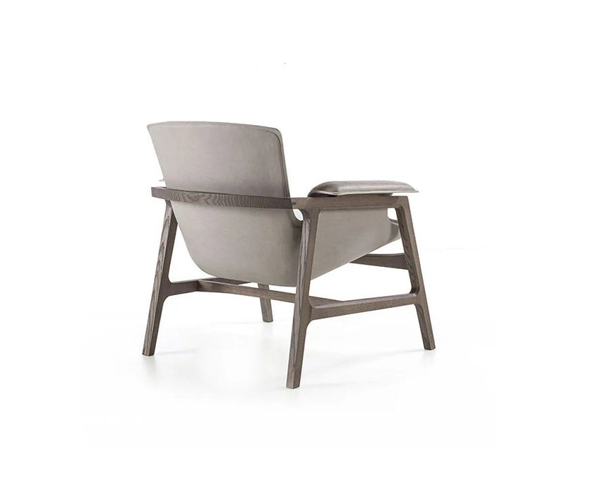 Luxury Arianna armchair by Frigerio with a solid ashwood frame and premium fabric or leather upholstery at Casa Design Group.