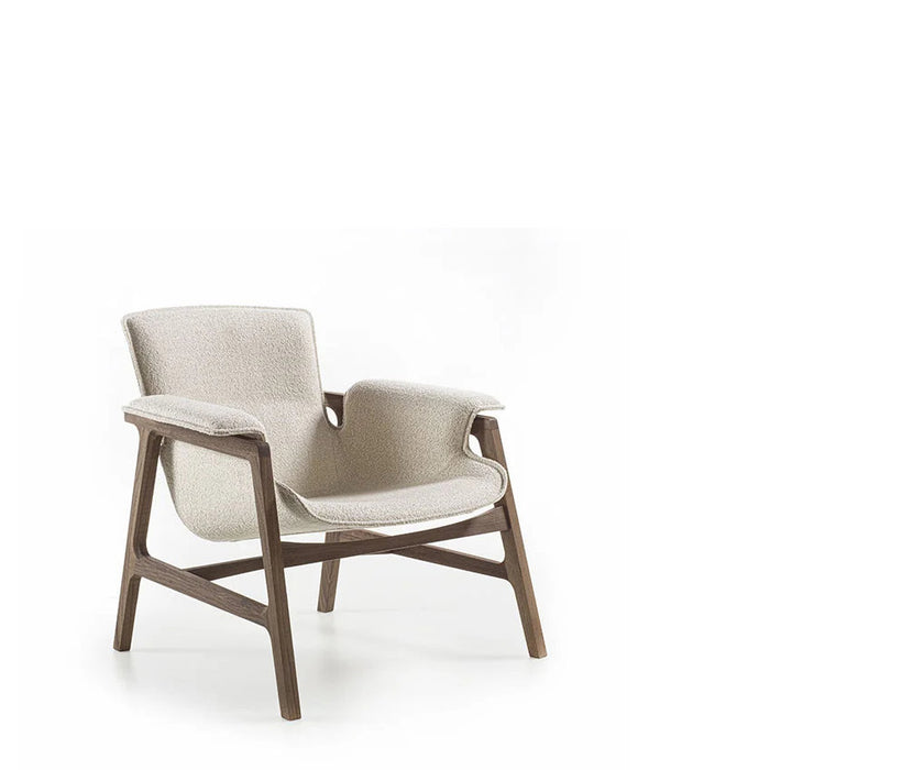 Luxury Arianna armchair by Frigerio with a solid ashwood frame and premium fabric or leather upholstery at Casa Design Group.