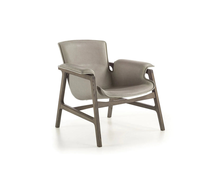 Luxury Arianna armchair by Frigerio with a solid ashwood frame and premium fabric or leather upholstery at Casa Design Group.