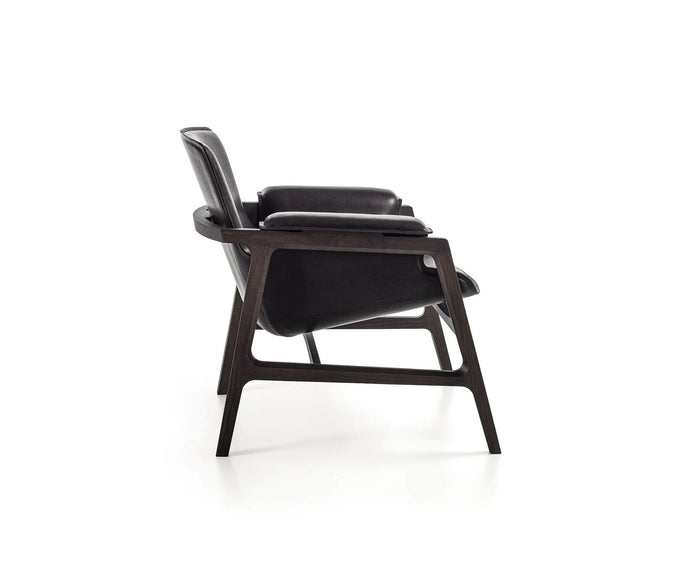 Luxury Arianna armchair by Frigerio with a solid ashwood frame and premium fabric or leather upholstery at Casa Design Group.