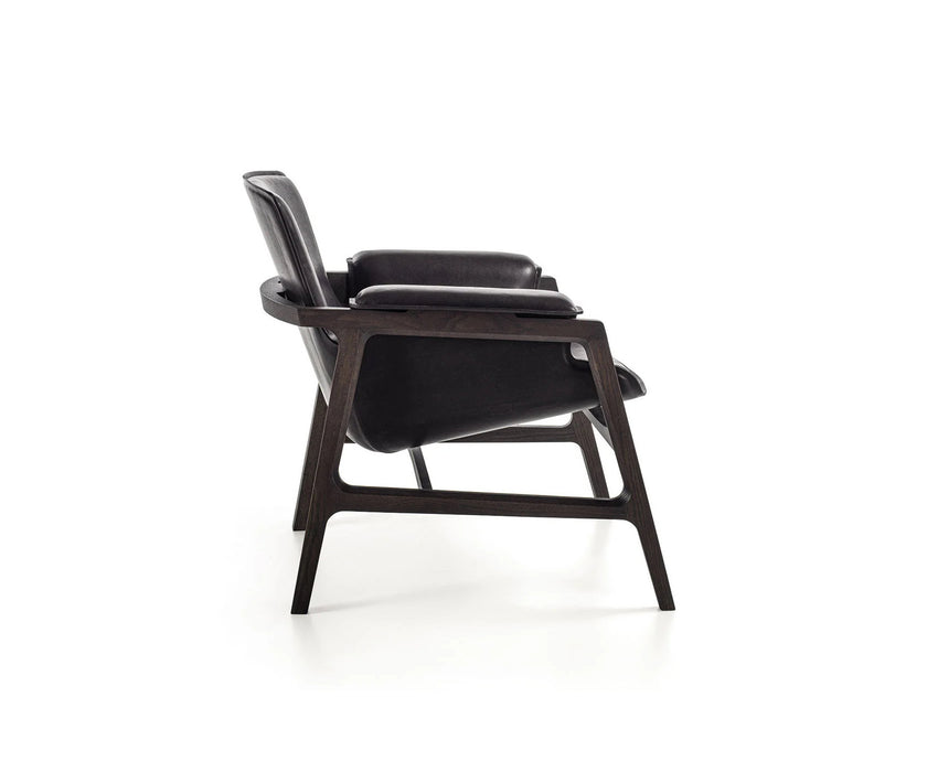 Luxury Arianna armchair by Frigerio with a solid ashwood frame and premium fabric or leather upholstery at Casa Design Group.