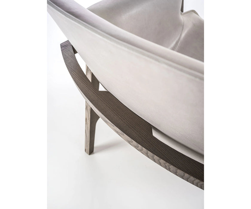 Luxury Arianna armchair by Frigerio with a solid ashwood frame and premium fabric or leather upholstery at Casa Design Group.