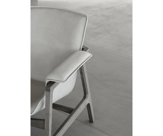 Luxury Arianna armchair by Frigerio with a solid ashwood frame and premium fabric or leather upholstery at Casa Design Group.