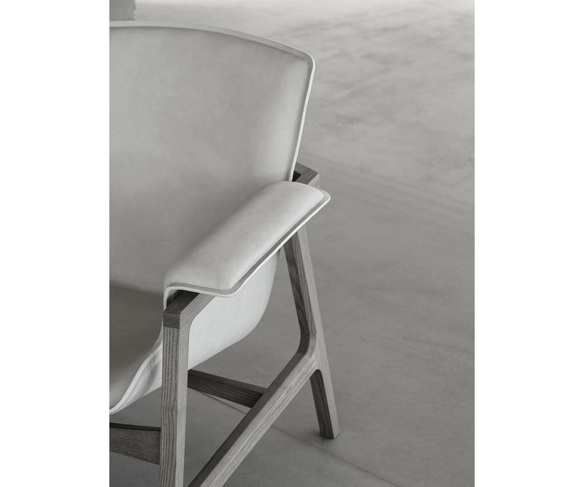 Luxury Arianna armchair by Frigerio with a solid ashwood frame and premium fabric or leather upholstery at Casa Design Group.