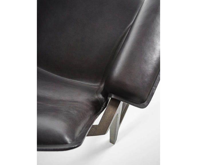 Luxury Arianna armchair by Frigerio with a solid ashwood frame and premium fabric or leather upholstery at Casa Design Group.