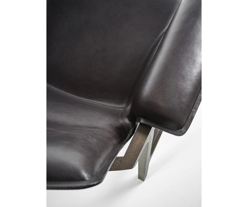 Luxury Arianna armchair by Frigerio with a solid ashwood frame and premium fabric or leather upholstery at Casa Design Group.