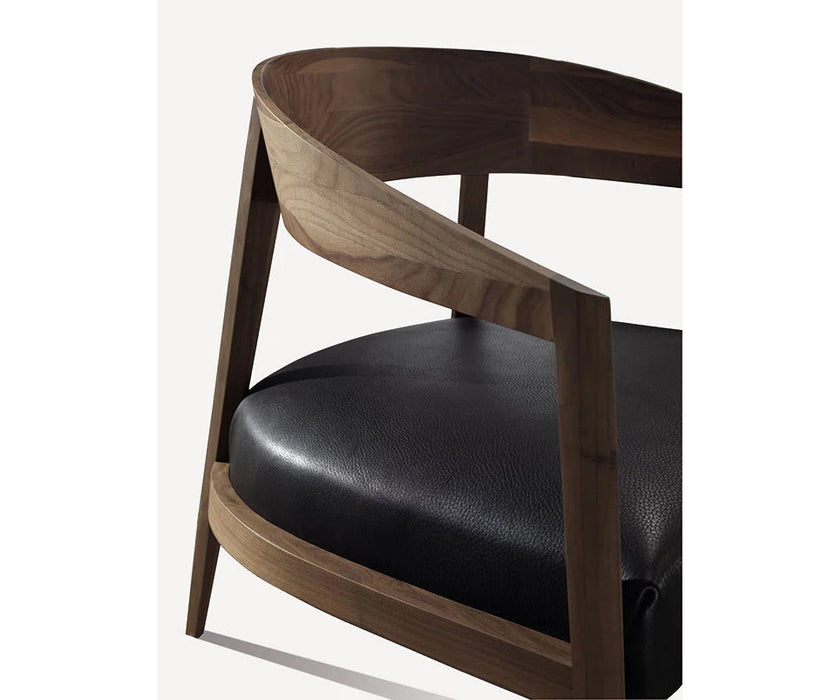 Luxury Lizzye armchair by Frigerio with a solid ashwood frame and premium fabric or leather upholstery | Casa Design Group