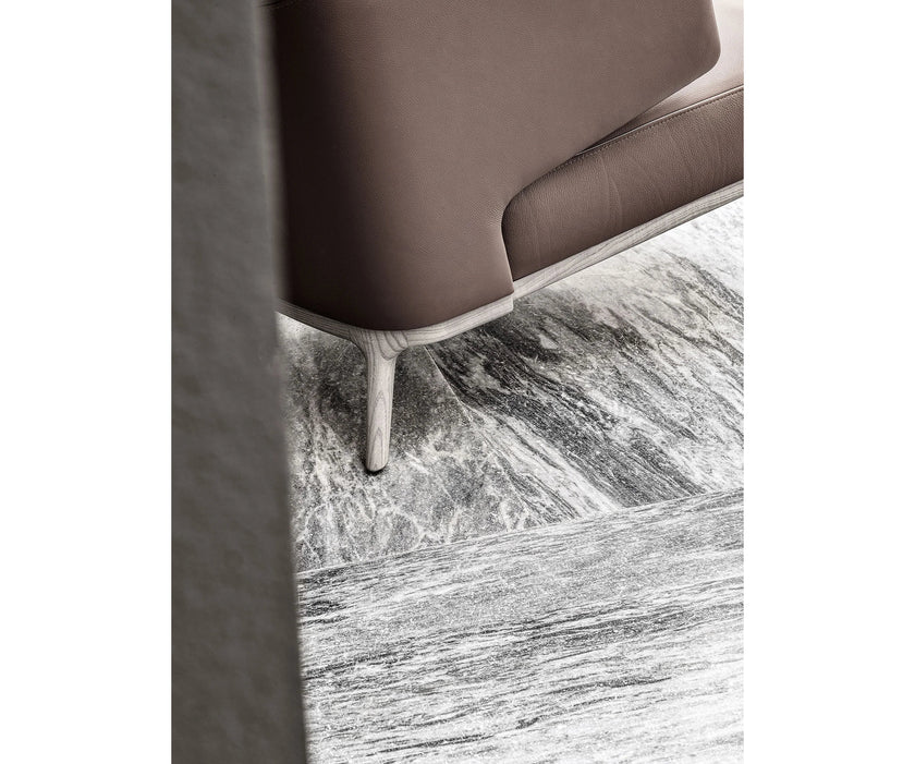 Amanda Lounge Chair by Frigerio featuring sculptural suspended armrests, a solid ashwood base, and premium Italian upholstery | Casa Design Group