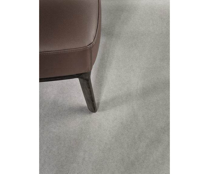 Amanda Lounge Chair by Frigerio featuring sculptural suspended armrests, a solid ashwood base, and premium Italian upholstery | Casa Design Group