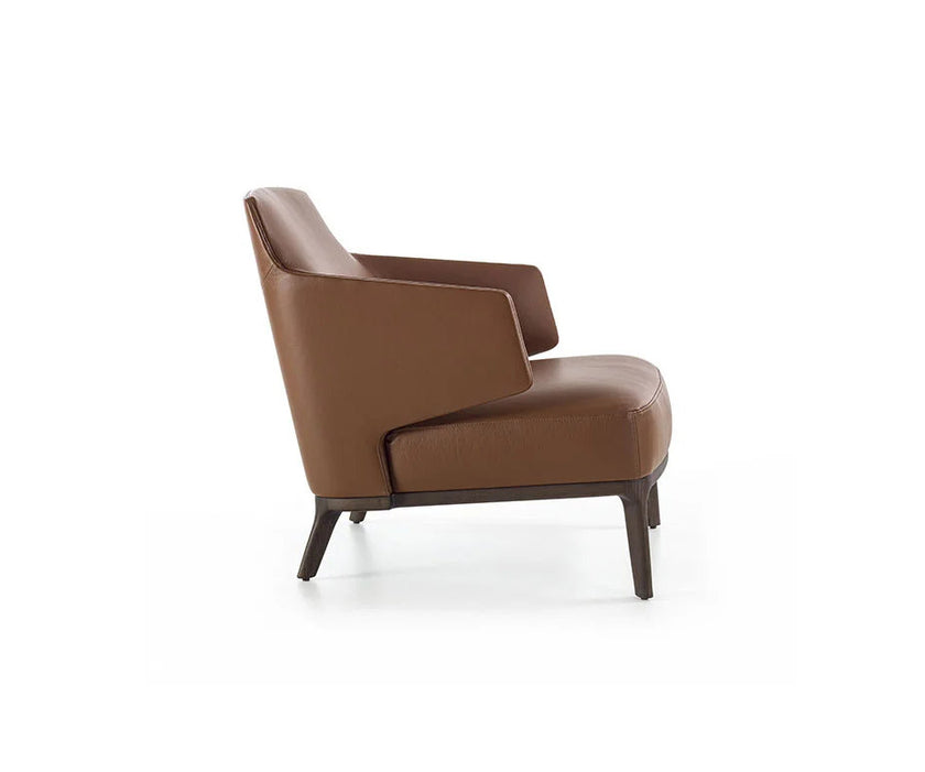 Amanda Lounge Chair by Frigerio featuring sculptural suspended armrests, a solid ashwood base, and premium Italian upholstery | Casa Design Group