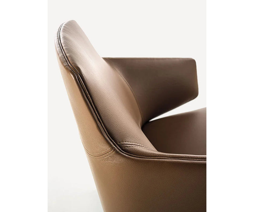 Amanda Lounge Chair by Frigerio featuring sculptural suspended armrests, a solid ashwood base, and premium Italian upholstery | Casa Design Group