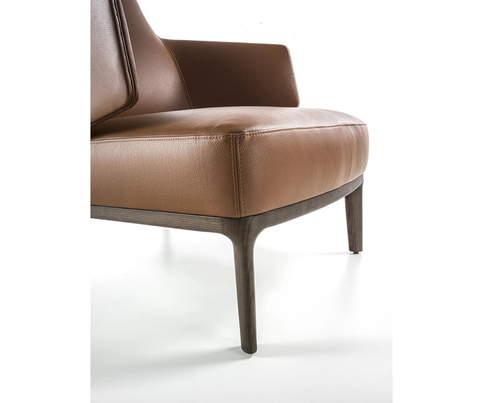 Amanda Lounge Chair by Frigerio featuring sculptural suspended armrests, a solid ashwood base, and premium Italian upholstery | Casa Design Group