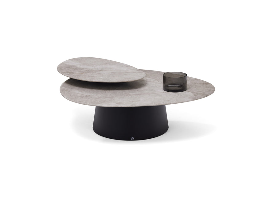Move Coffee Table by Draenert with rotating natural stone tops and a conical metal base.