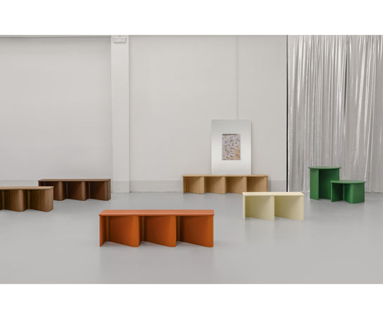 Nami Bench by Miniforms with a sculptural bent wood base and contemporary design.