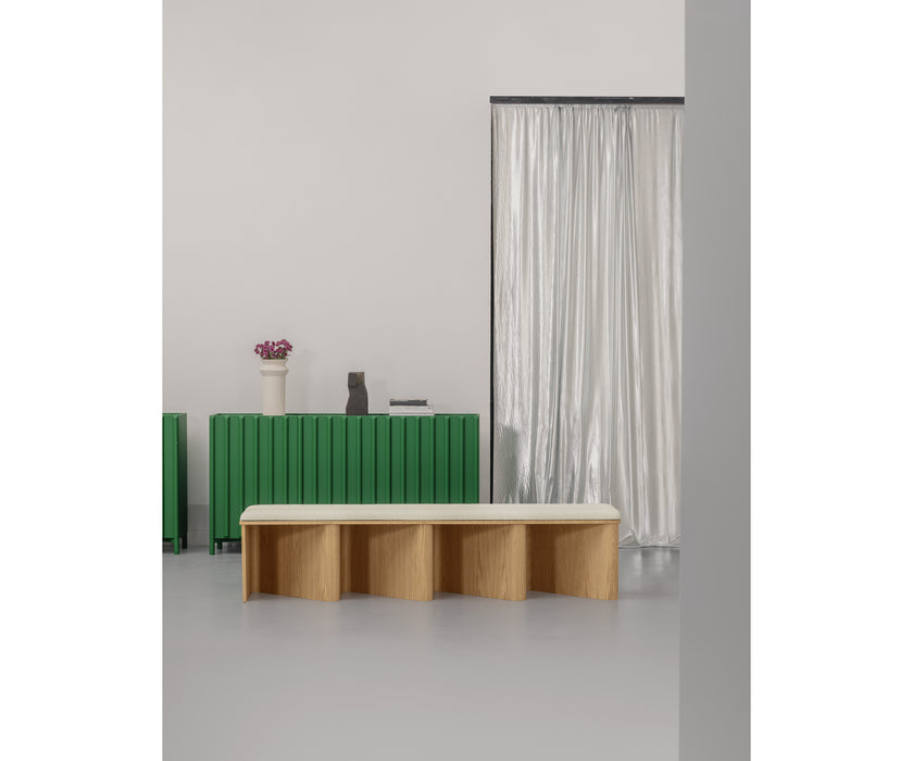 Nami Bench by Miniforms with a sculptural bent wood base and contemporary design.