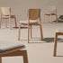 Naqi Dining Chair with solid wood frame and interchangeable upholstered seat by Skram | Casa Design Group