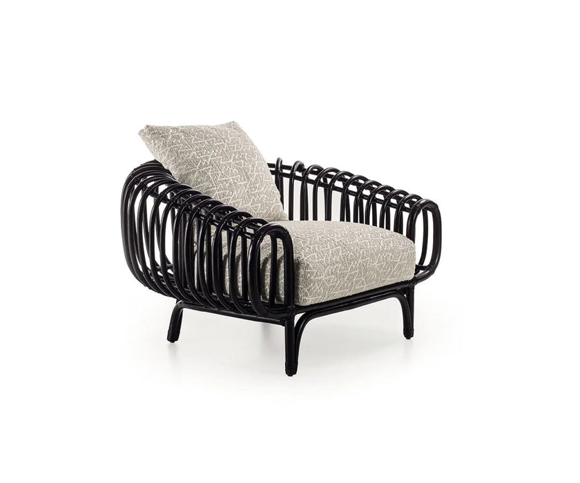 Pan Lounge Chair by Frigerio with handcrafted black reed frame and plush upholstered cushions for luxury interiors.