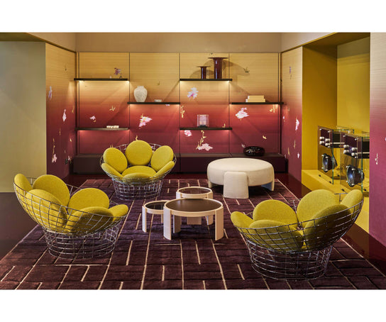 Peacock Lounge Chair by Cassina with a polished stainless steel mesh frame and seven upholstered cushions.