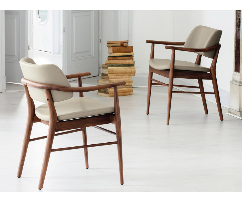 Porada Nissa dining armchair with a solid Canaletta walnut frame and fabric or leather upholstery | Casa Design Group