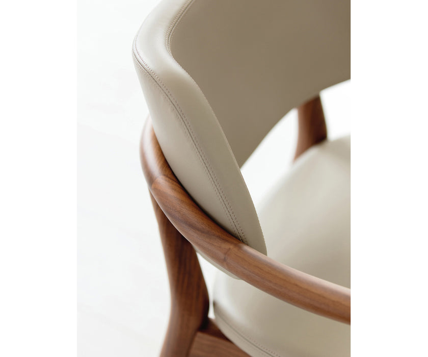 Porada Nissa dining armchair with a solid Canaletta walnut frame and fabric or leather upholstery | Casa Design Group