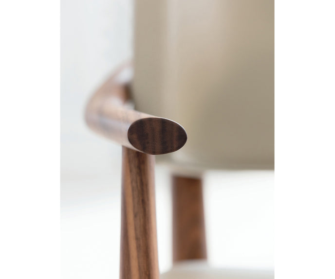 Porada Nissa dining armchair with a solid Canaletta walnut frame and fabric or leather upholstery | Casa Design Group