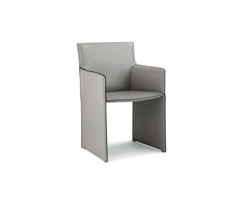 Qualina dining armchair by Enrico Pellizzoni upholstered in leather with contemporary design – Casa Design Group