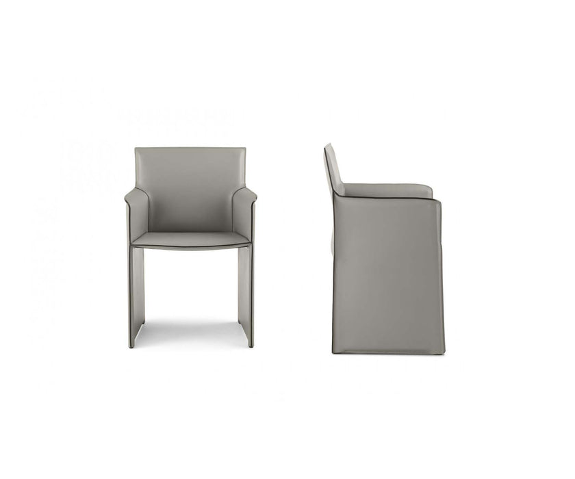 Qualina dining armchair by Enrico Pellizzoni upholstered in leather with contemporary design – Casa Design Group