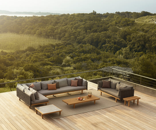 Luxury teak outdoor bench with cushions from Dedon’s Sealine collection – Casa Design Group