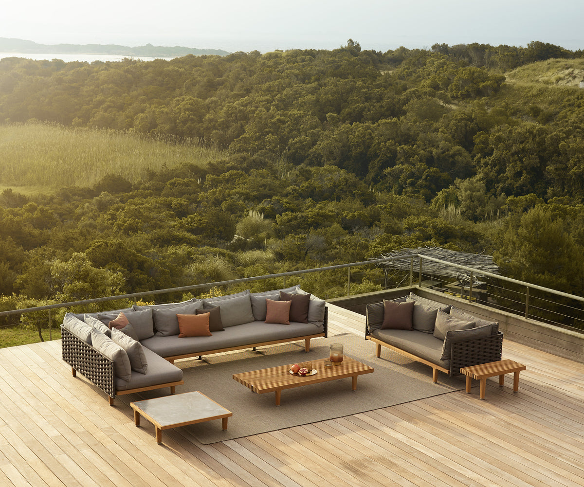Luxury teak outdoor bench with cushions from Dedon’s Sealine collection – Casa Design Group