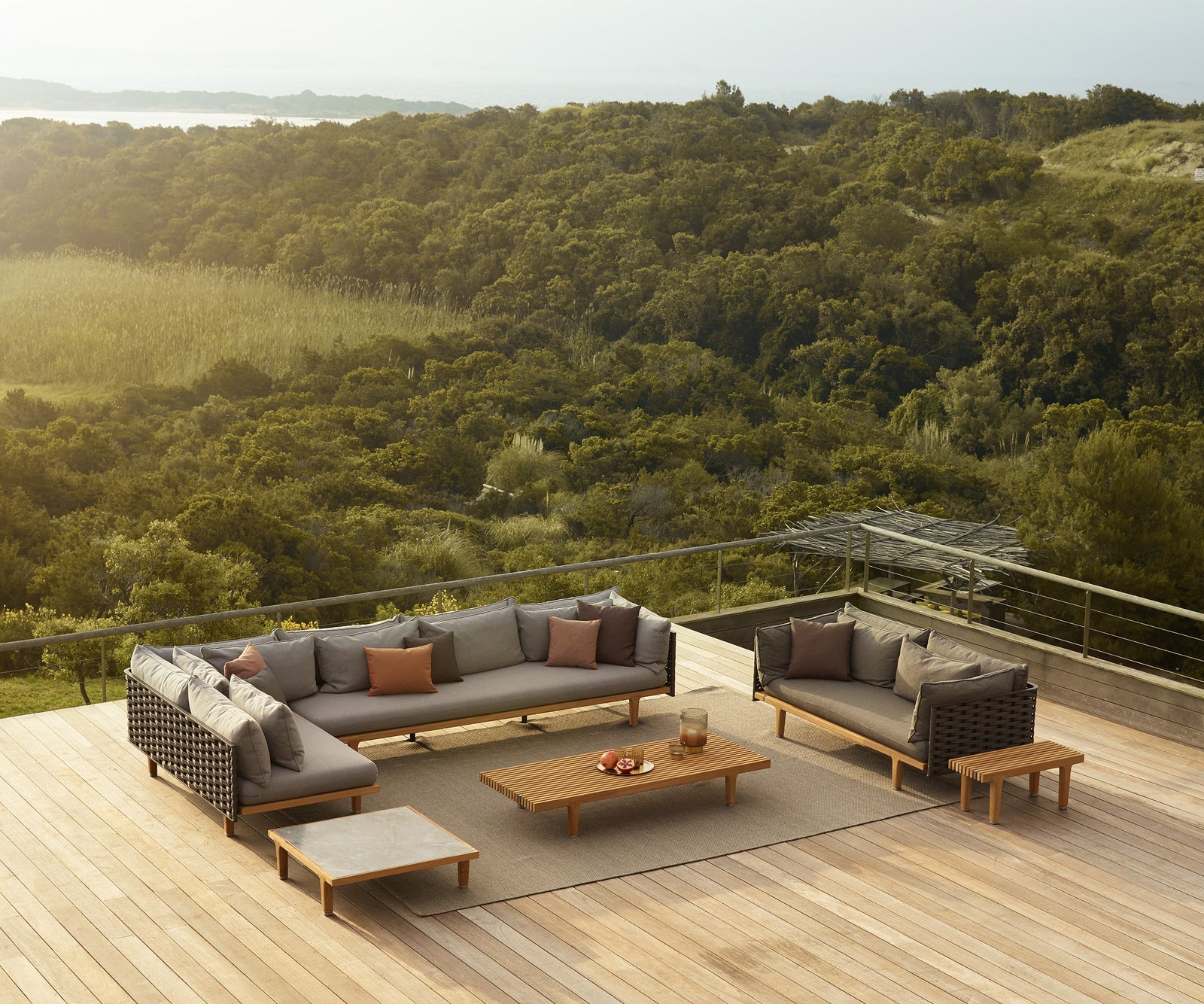Luxury teak outdoor bench with cushions from Dedon’s Sealine collection – Casa Design Group