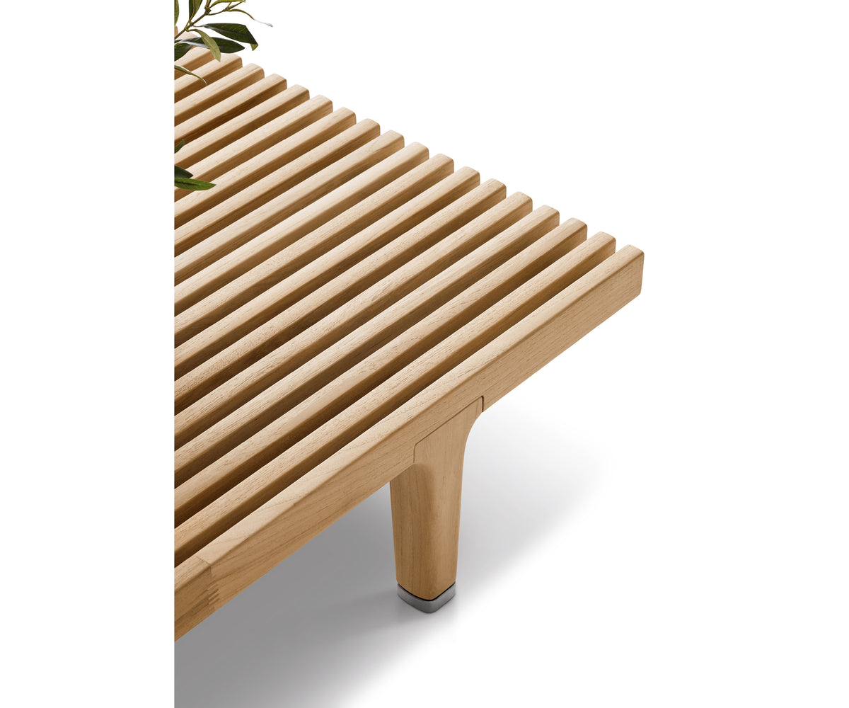 Luxury teak outdoor bench with cushions from Dedon’s Sealine collection – Casa Design Group