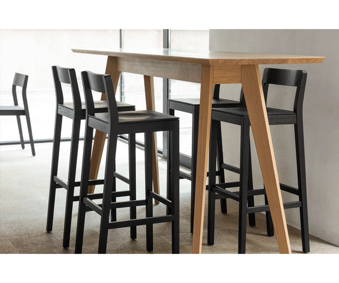 Sit Bar Chair by Zeitraum featuring minimalist solid wood construction, upholstered seat options, and ergonomic footrest | Casa Design Group