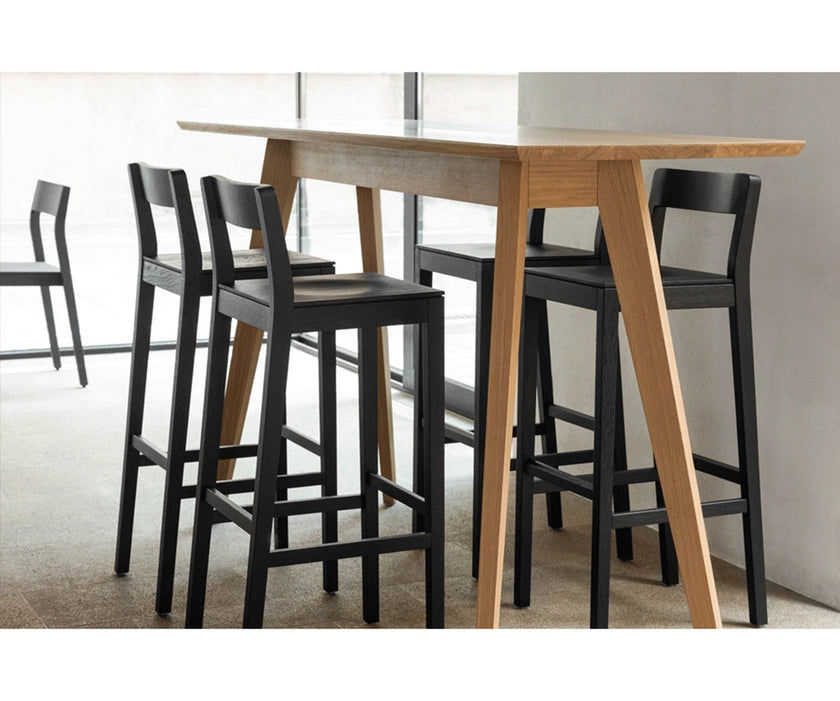 Sit Bar Chair by Zeitraum featuring minimalist solid wood construction, upholstered seat options, and ergonomic footrest | Casa Design Group