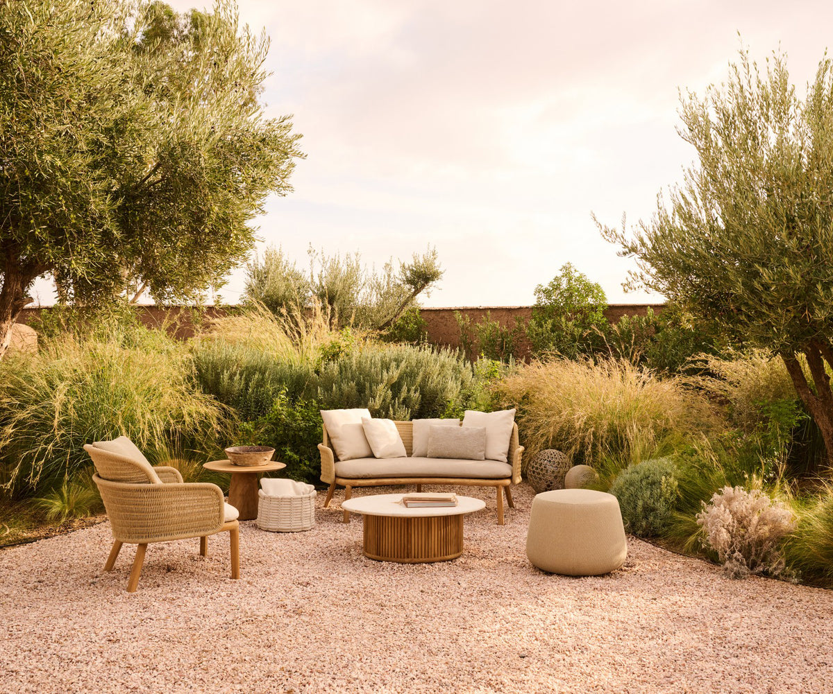 Elegant Suro Outdoor Sofa by Tribù with teak wood and braided rope | Casa Design Group