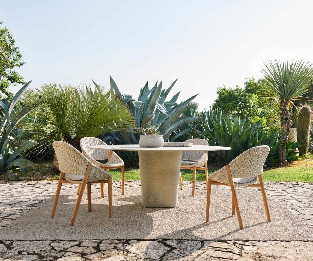 Tao Round Outdoor Dining Table by Tribù with sculptural pedestals and refined concrete top | Casa Design Group.