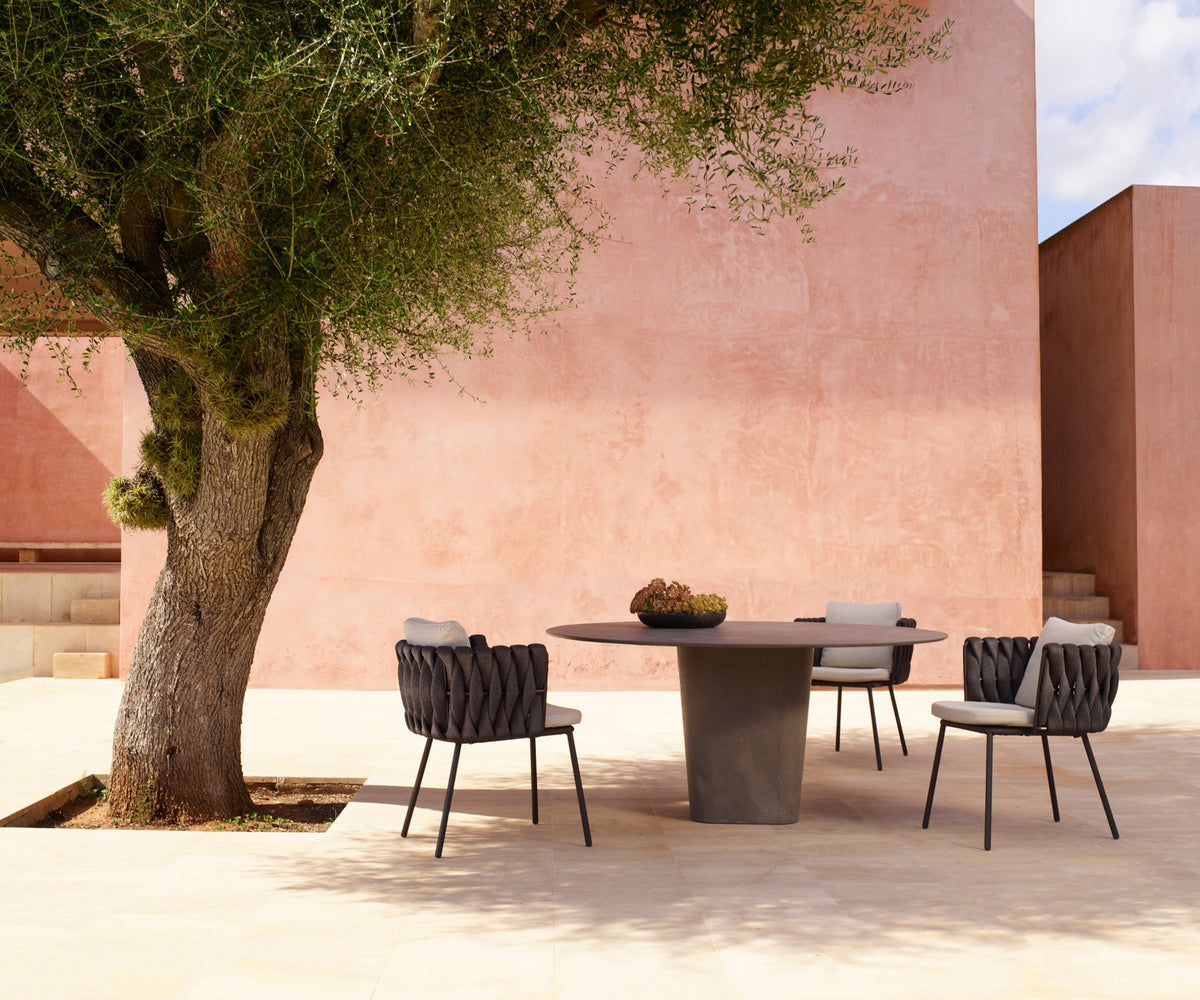 Tao Round Outdoor Dining Table by Tribù with sculptural pedestals and refined concrete top | Casa Design Group.