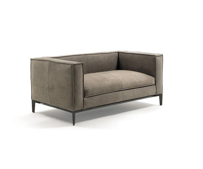 Taylor Medium Sofa by Frigerio featuring a contemporary modular design with clean lines, upholstered seating, and a sleek metal base.