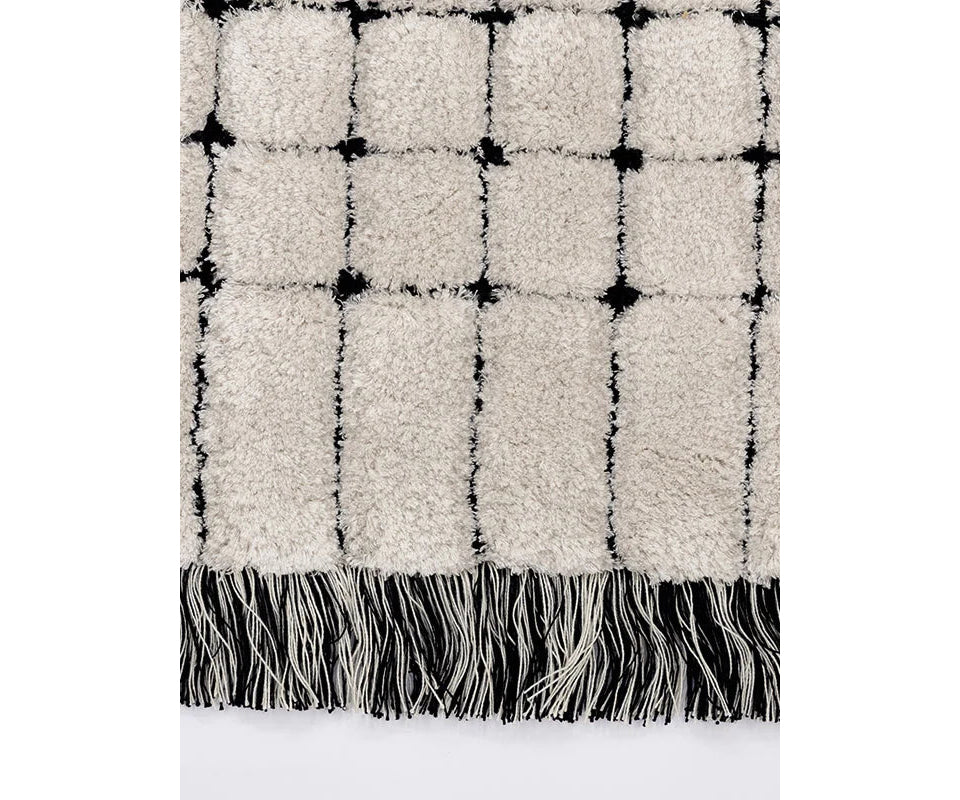 Frigerio Theo Rug with hand-tufted texture and refined geometric detailing for luxury interiors Casa Design Group