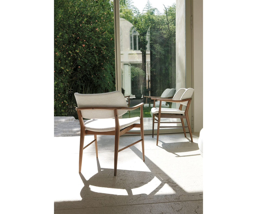 Porada Nissa dining armchair with a solid Canaletta walnut frame and fabric or leather upholstery | Casa Design Group